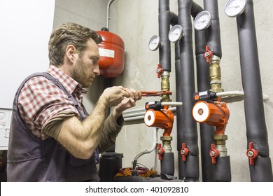 Plumber At Work Installing A Circulation Pump