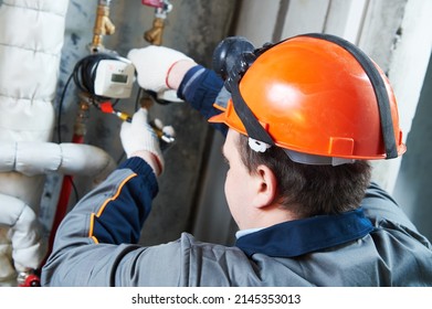 Plumber Worker Works With Heating Water Meter