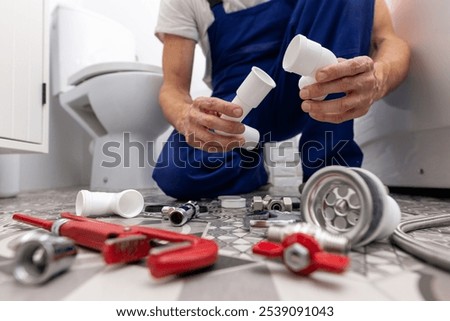 plumber working in bathroom. installing drain pipes. plumbing services
