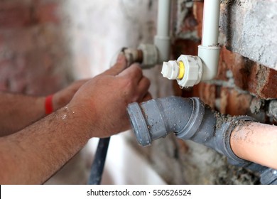 Plumber Working On Pipes.