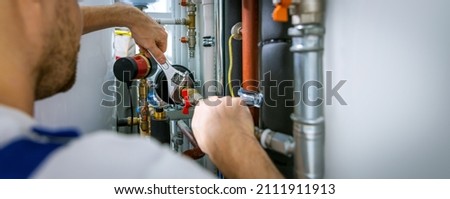 plumber working with wrench. screws the pipe fittings. banner copy space