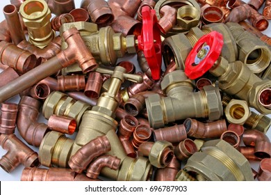 Plumber's pipes and fittings   –    Random mixture of copper pipe and brass fittings ideal for use as a website header  background