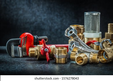 plumbing brass pipe connectors on dark background