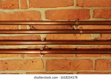 Plumbing Copper Pipes On Brick Wall