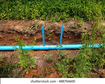 Plumbing Embedded Underground With Blue PVC Pipe On Dirt Land, Soil Was Dug For Water Transportation By Pipeline 