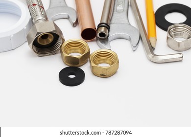 Plumbing Essential Tools On A Plain Background