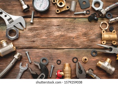 Plumbing flat lay background with copy space. Work tools and pipeline parts on plumber workbench.