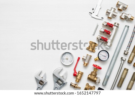 Plumbing flat lay concept background with copy space. Various water system accessories on white background.
