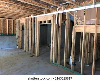 Plumbing and framing in basement - Shutterstock ID 1163325817