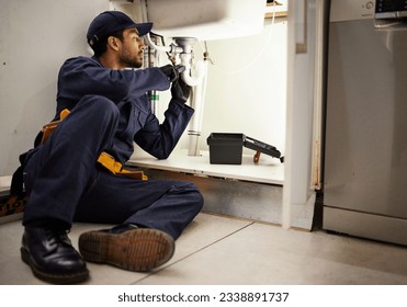 Plumbing, handyman and maintenance with man in kitchen for repair, industrial and inspection. Pipes, tools and safety with male plumber fixing sink for home improvement, drainage and water system - Powered by Shutterstock