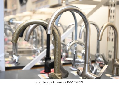 Plumbing And Kitchen Faucets At Exhibition In Store. Plumbing Shop Faucets For The Kitchen Bath Equipment. 