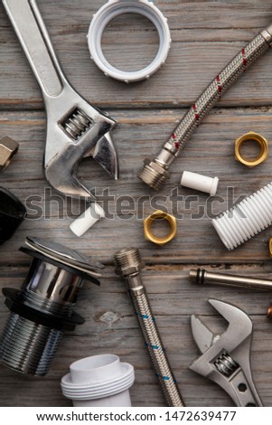Plumbing layout. Tools and acessories on a wooden background