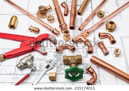 Plumbing Tools Arranged On House Plans whit wrench and pipe cutter