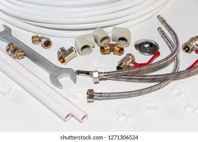 Plumbing Tools And Equipment On White With Copy Space