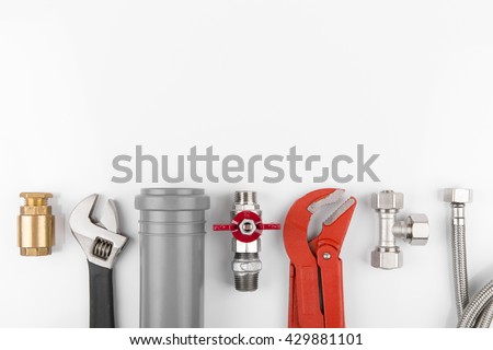 plumbing tools and equipment on white with copy space