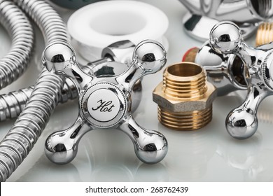 plumbing and tools in a light background. focus on the word hot