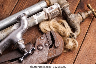 Plumbing Tools Lying With Old Pipes And Faucets