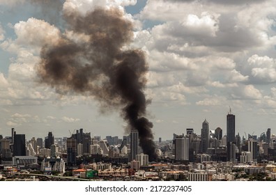 Plume Of Black Smoke Clouds From Burnt Building On Fire At Community Area In The Bangkok City. Fire Disaster Accident, No Focus, Specifically.