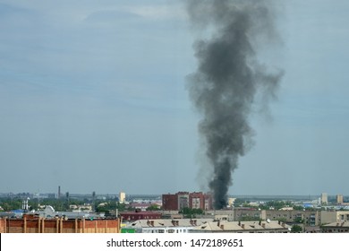 Plume Of Smoke Above City. Aerial View On City Fire. Air Pollution Over Homes.