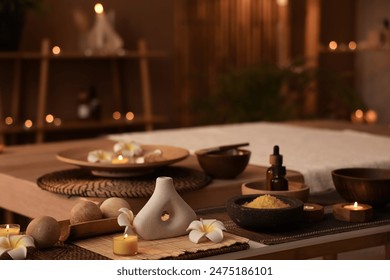 Plumeria flowers with massage balls and sea salt on table in dark spa salon, closeup - Powered by Shutterstock