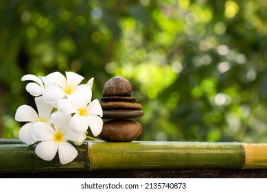 Plumeria flowers and stone on bokeh nature background.