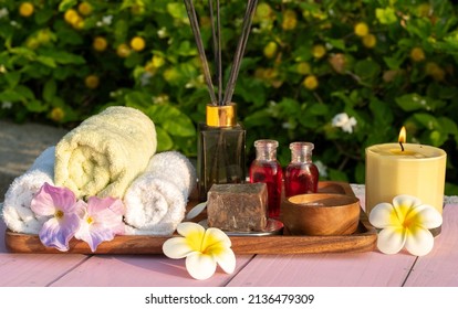 Plumeria Towel With Pink Salt Scrub, Spa Massage Oil, Aromatherapy Soap And Scented Candle, Prepare To Make A Spa Salon. 