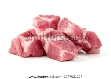 Plump, fresh raw pork cubes, featuring vibrant pink muscle and clean white fat ready for stewing or roasting, arranged naturally, isolated on white background