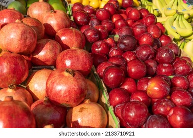 Plums, Pomegranates And Other Fruit On A Market Stall In The UK.