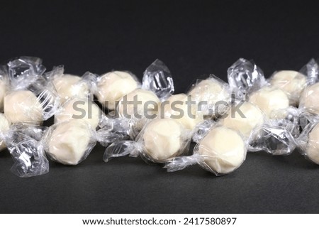 Plural candy cheese on black background