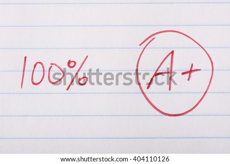 A plus (A+) grade with one hundred percent written in red pen on notebook paper.
