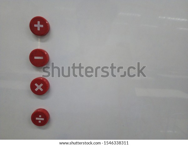 The\
plus, minus, multiply symbol is on the white\
board.