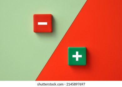 Plus and minus signs on a multi-colored background. Positive and negative information