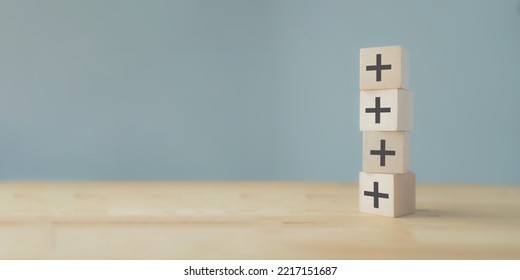 Plus sign in wooden cubes stacking. Positive things; additional, added value, benefits, improve, develop, growth mindset, positive thinking, motivation, increase, opportunities, and emerging market. - Shutterstock ID 2217151687