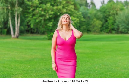 Plus size American blonde woman in pink midi dress at nature. Life of people xl size, happy nice natural beauty woman