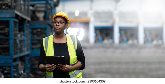 Plus size black female worker wearing safety hard hat helmet inspecting old car parts stock while working in automobile large warehouse - Shutterstock ID 2193104309