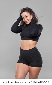 Plus Size Confident Young Woman Doing Fitness Exercises On Gray Background