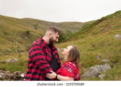 Plus Size Couple In An Embrace Out On A Travel Adventure On A Mountain In Wales