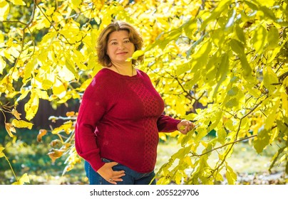 Plus size European or American mature woman at park, enjoy the life, walks. Life of people xl size, happy nice natural beauty woman. Concept of overweight