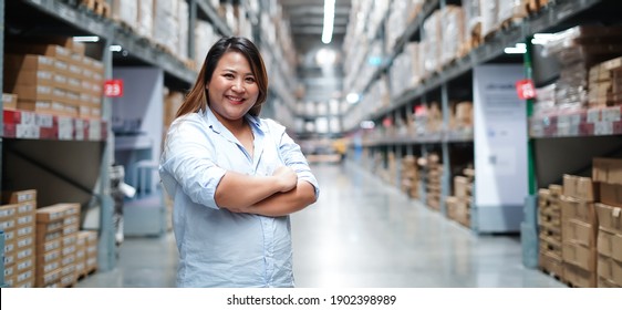 Plus size female worker inspecting box of products while working in large warehouse - Powered by Shutterstock