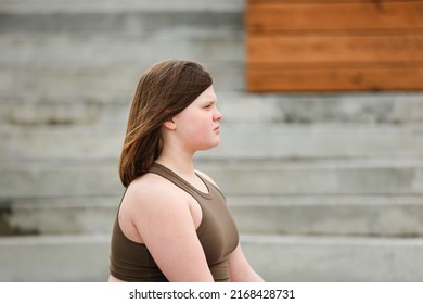 Plus Size Girl Teenager Meditates On Yoga Mat Outside In Summer, Excess Weight In Teenagers, Calmness And Yoga Classes