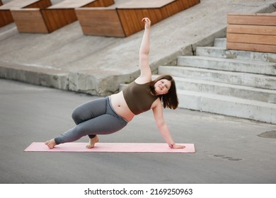 Plus Size Girl Teenager Meditates On Yoga Mat Outside In Summer, Excess Weight In Teenagers, Calmness And Yoga Classes