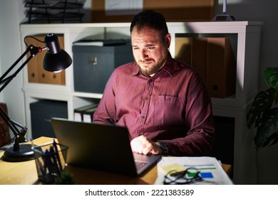 Plus Size Hispanic Man With Beard Working At The Office At Night Depressed And Worry For Distress, Crying Angry And Afraid. Sad Expression. 