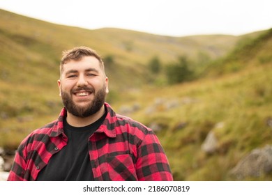 Plus size male in button down shirt smiling outside on an adventure - Powered by Shutterstock