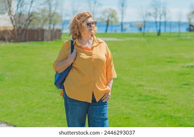 Plus size middle age lady in yellow shirt and blue jeans. Fashionable woman in casual style - Powered by Shutterstock