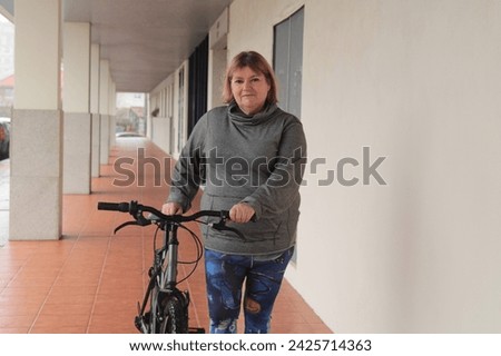 plus size middle aged woman riding her bicycle through the city