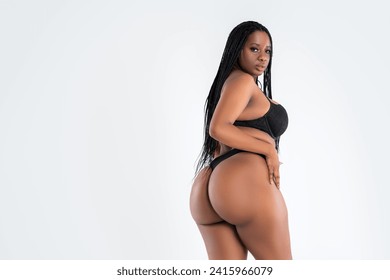 Plus size model in lingerie, fat sexy curvy African black woman in underwear on gray studio background, overweight thigh, hips and buttocks, obesity female body with cellulite, fat body