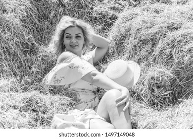 Plus size model in romantic style at the hay. Concept of fashionable style and vogue