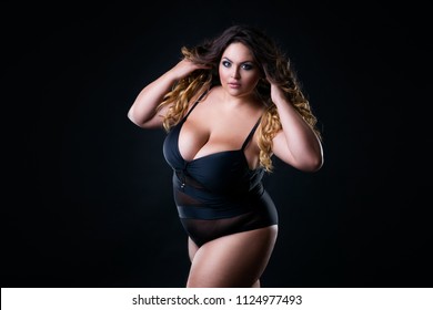 Plus size sexy model in swimsuit, fat woman with big natural breast on black studio background, overweight female body