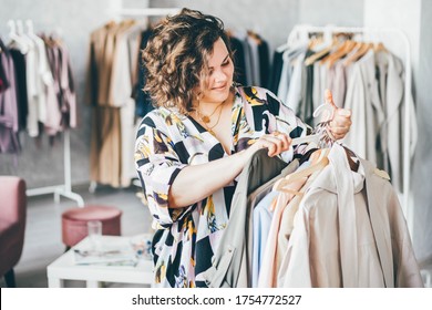  Plus Size Woman Choose Fashioned Dress in Store. Plus size women shopping.
