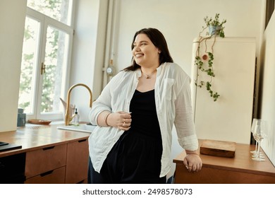 A plus size woman enjoys her time at home in a stylish kitchen. - Powered by Shutterstock